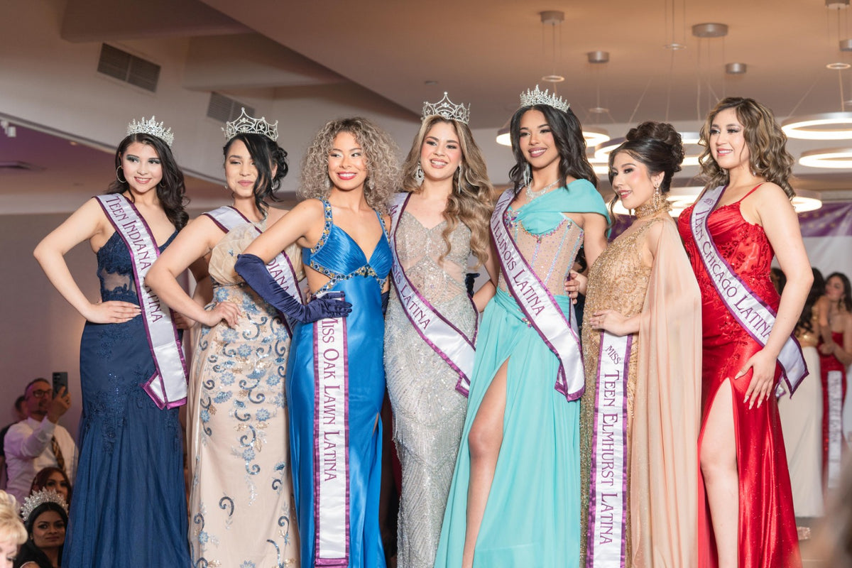 A group of seven titleholders posing together at a pageant celebration